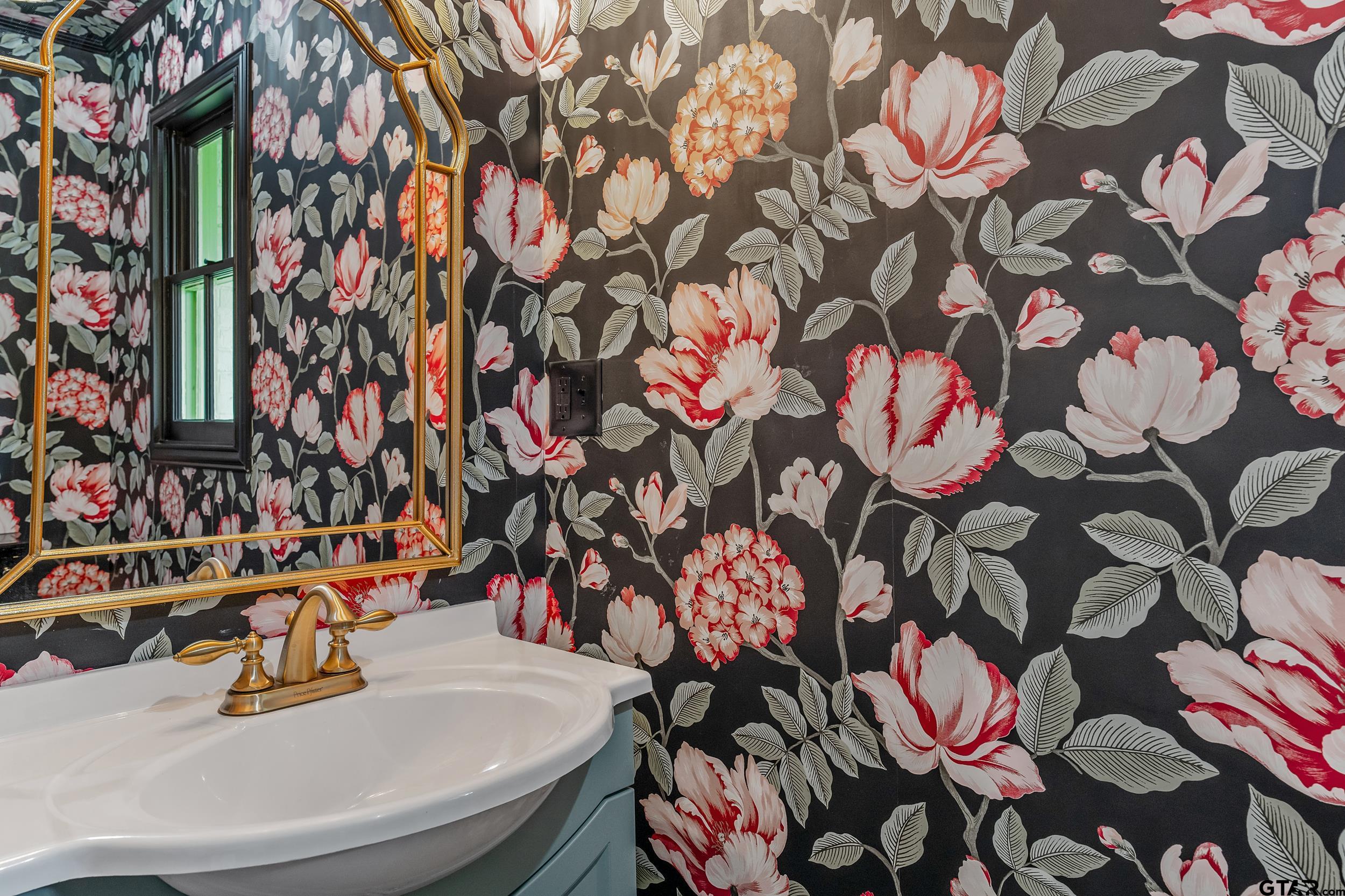 606 Tremont Place Tyler, TX 75701 - Photo 44 of 48 a bathroom with a sink and mirror with toilet