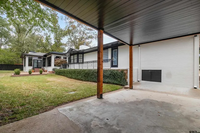 a view of a house with backyard and sitting area