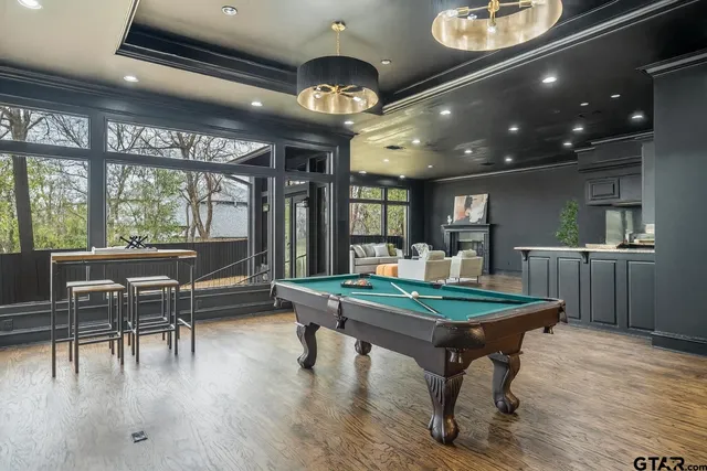 a room with stainless steel appliances lots of wooden furniture