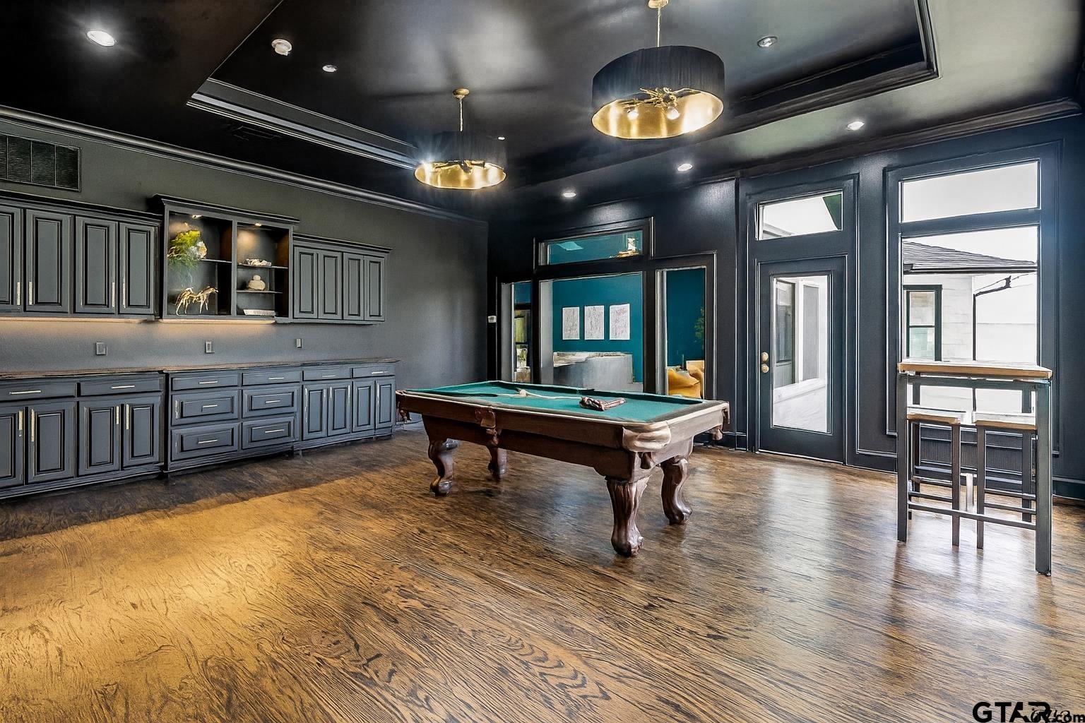 606 Tremont Place Tyler, TX 75701 - Photo 7 of 48 a living room with furniture a chandelier and a wooden floor