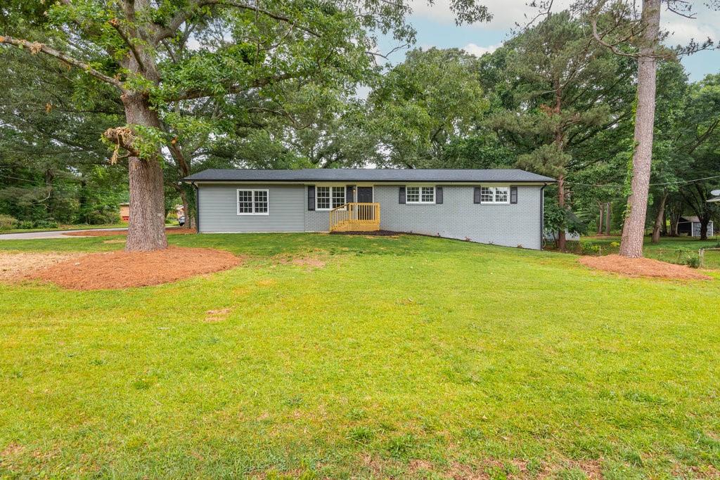 A fully renovated ranch with a large finished area in the basement sits on a large, level corner lot.