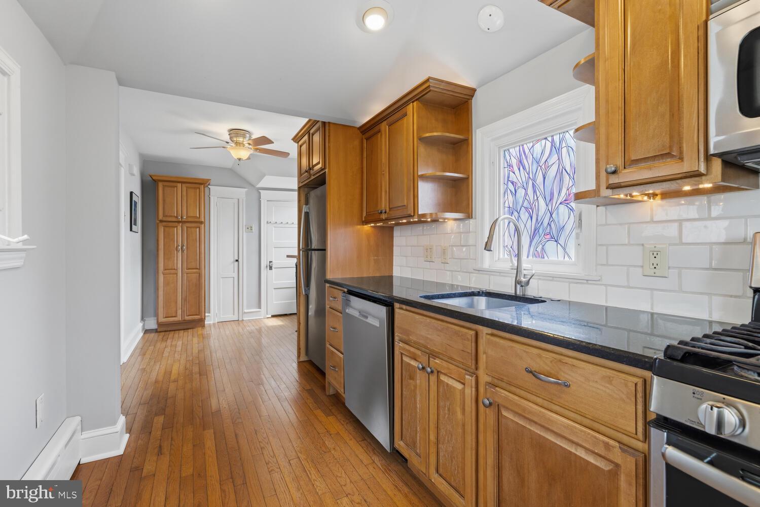 2116 East County Line Road Ardmore, PA 19003 - Photo 16 of 38 a kitchen with granite countertop wooden floors and sink