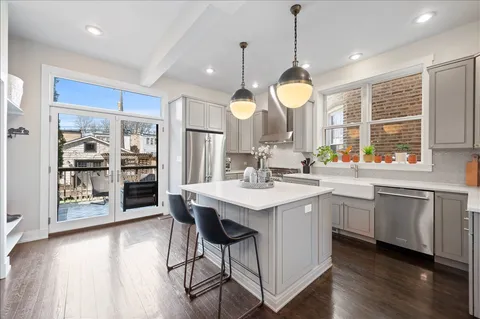 a kitchen with center island table and chairs in it