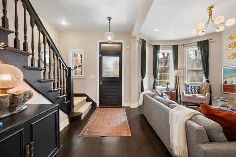 a living room with furniture stove and a large window