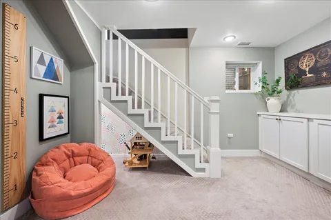 a spacious bedroom with a bed a desk and chair