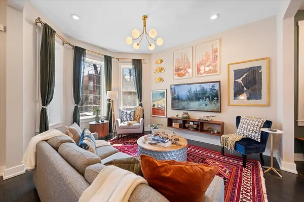 a living room with furniture and a chandelier