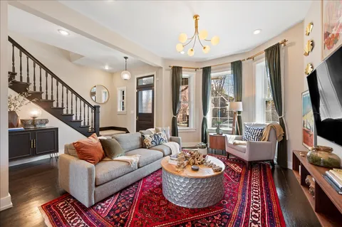 a living room with furniture and a chandelier