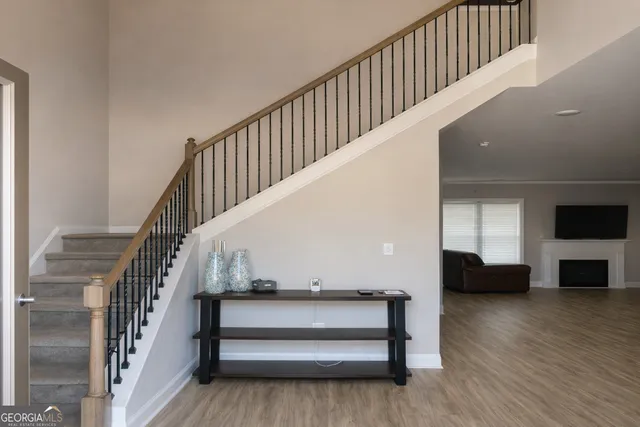a view of entryway and hall with wooden floor