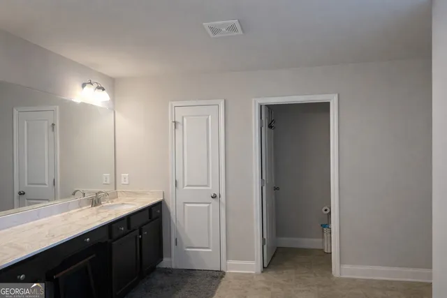a bathroom with a double vanity sink and a mirror