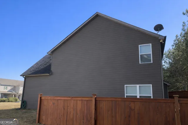 a backyard of a house with wooden fence
