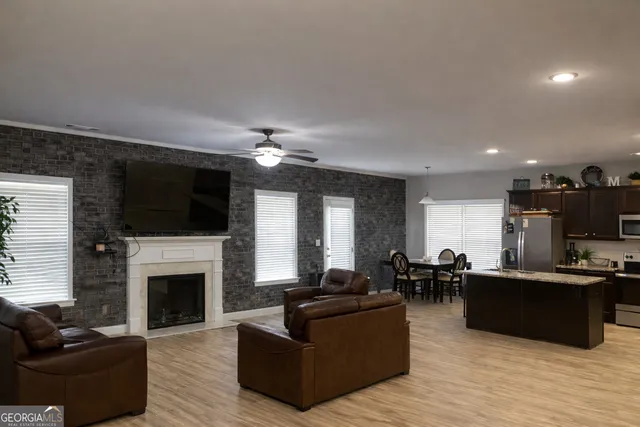 a living room with furniture a fireplace and a flat screen tv