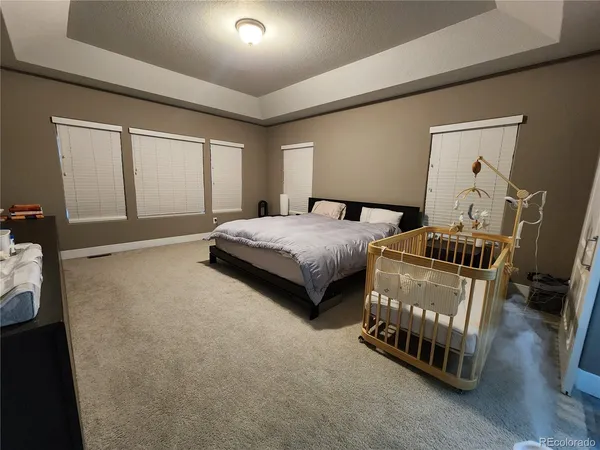 a bedroom with bed and a window