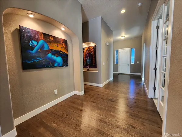 a view of a hallway with wooden floor