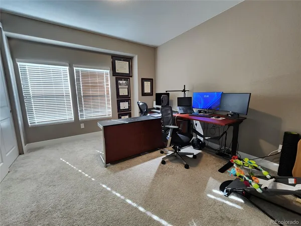 a view of a workspace with furniture and a window