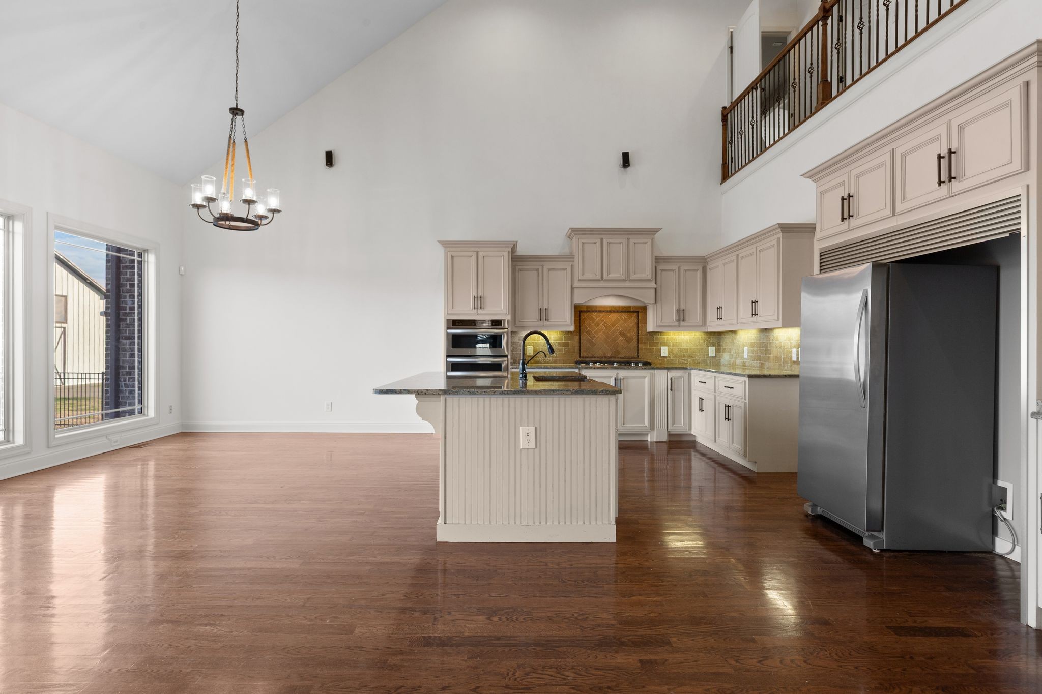 7607 Midland Road Christiana, TN 37037 - Photo 21 of 48 a kitchen with stainless steel appliances granite countertop a refrigerator a sink dishwasher a stove and white cabinets with wooden floor