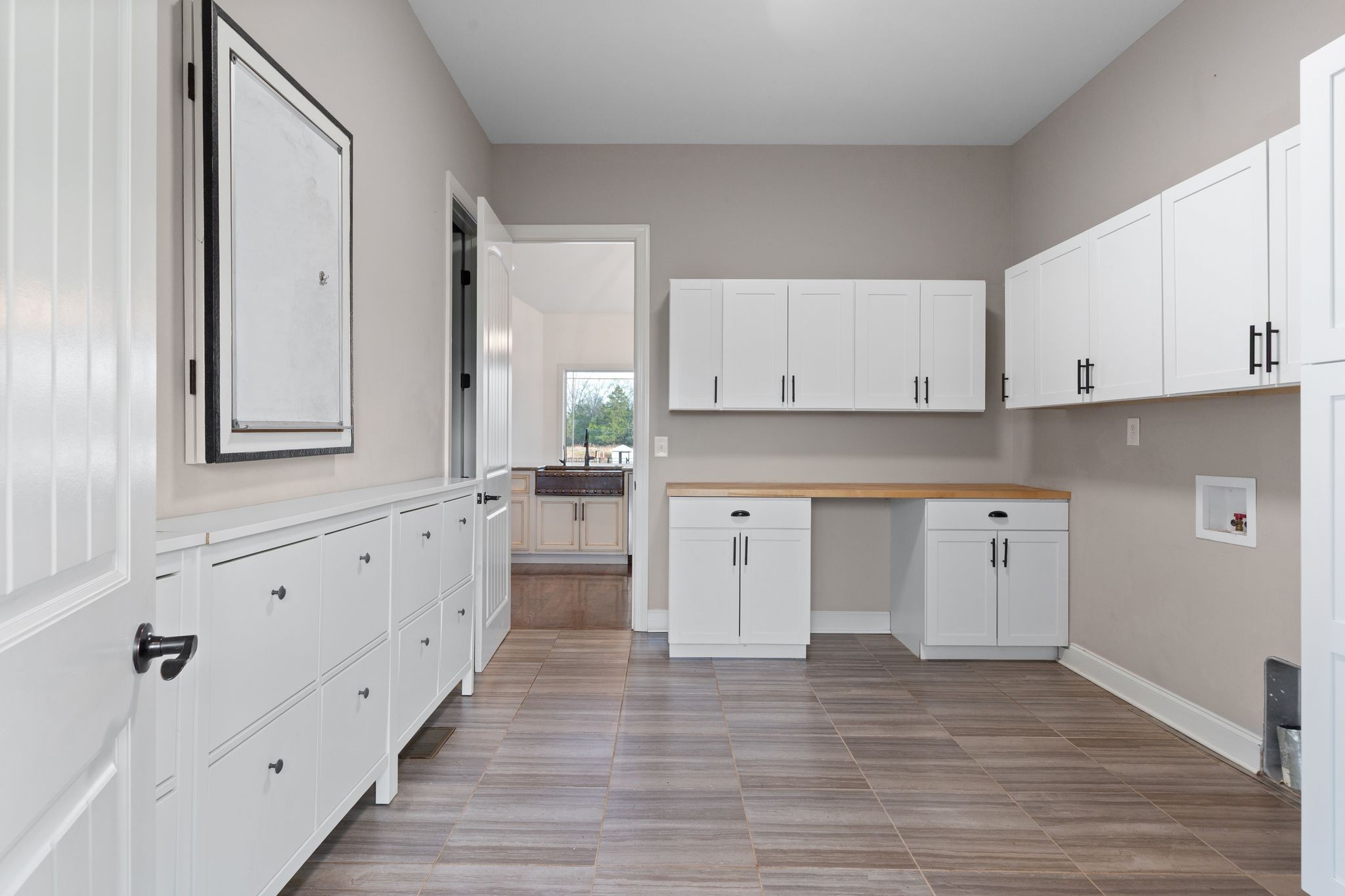 7607 Midland Road Christiana, TN 37037 - Photo 28 of 48 a large white kitchen with granite countertop a stove a sink and white cabinets with wooden floor
