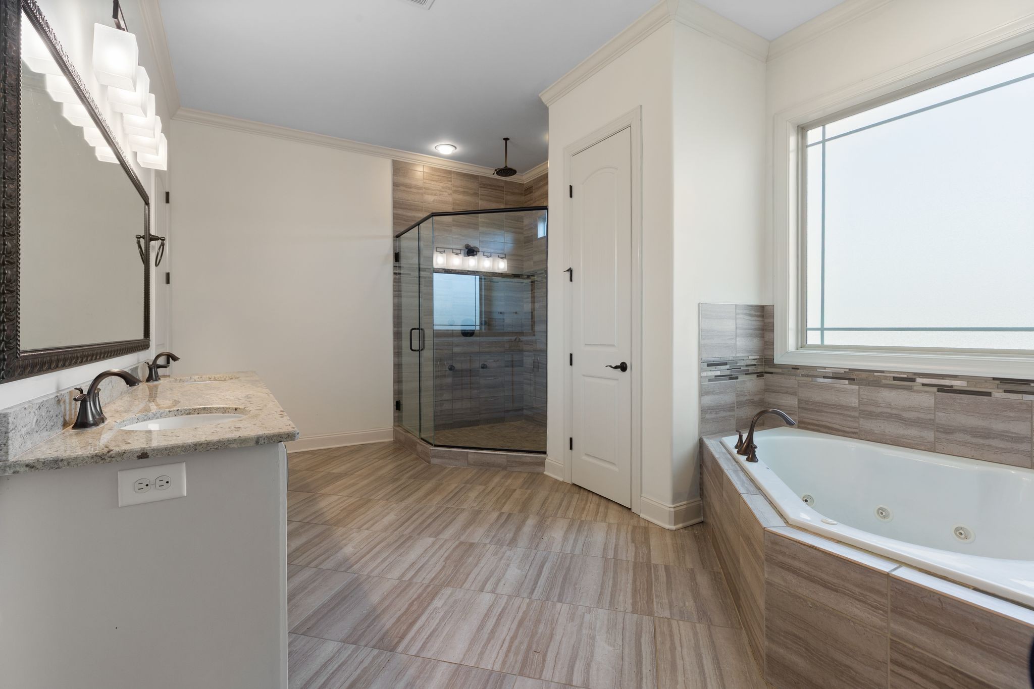 7607 Midland Road Christiana, TN 37037 - Photo 32 of 48 a bathroom with a granite countertop bathtub sink and mirror