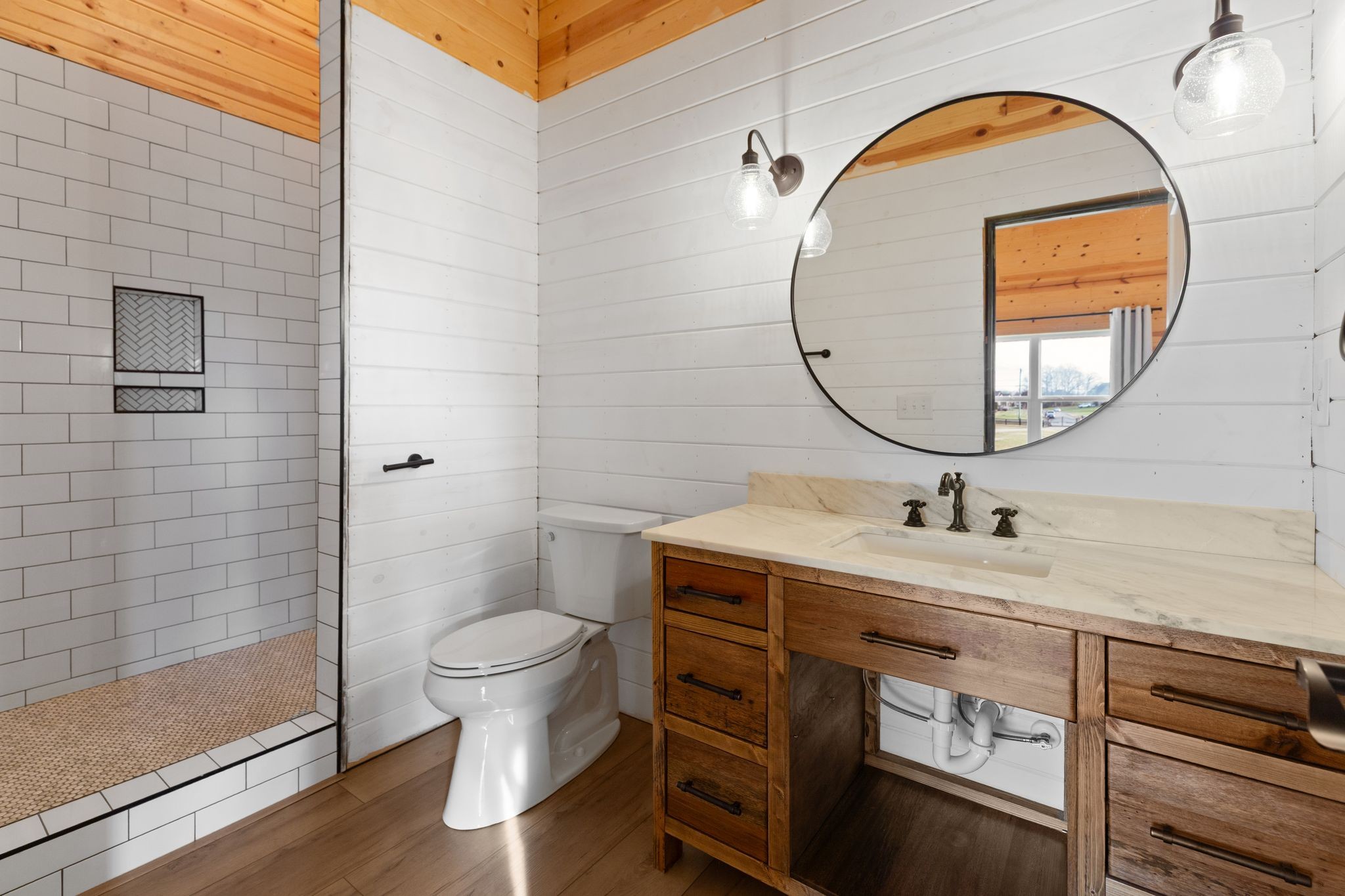 7607 Midland Road Christiana, TN 37037 - Photo 40 of 48 a bathroom with a toilet a sink and a mirror