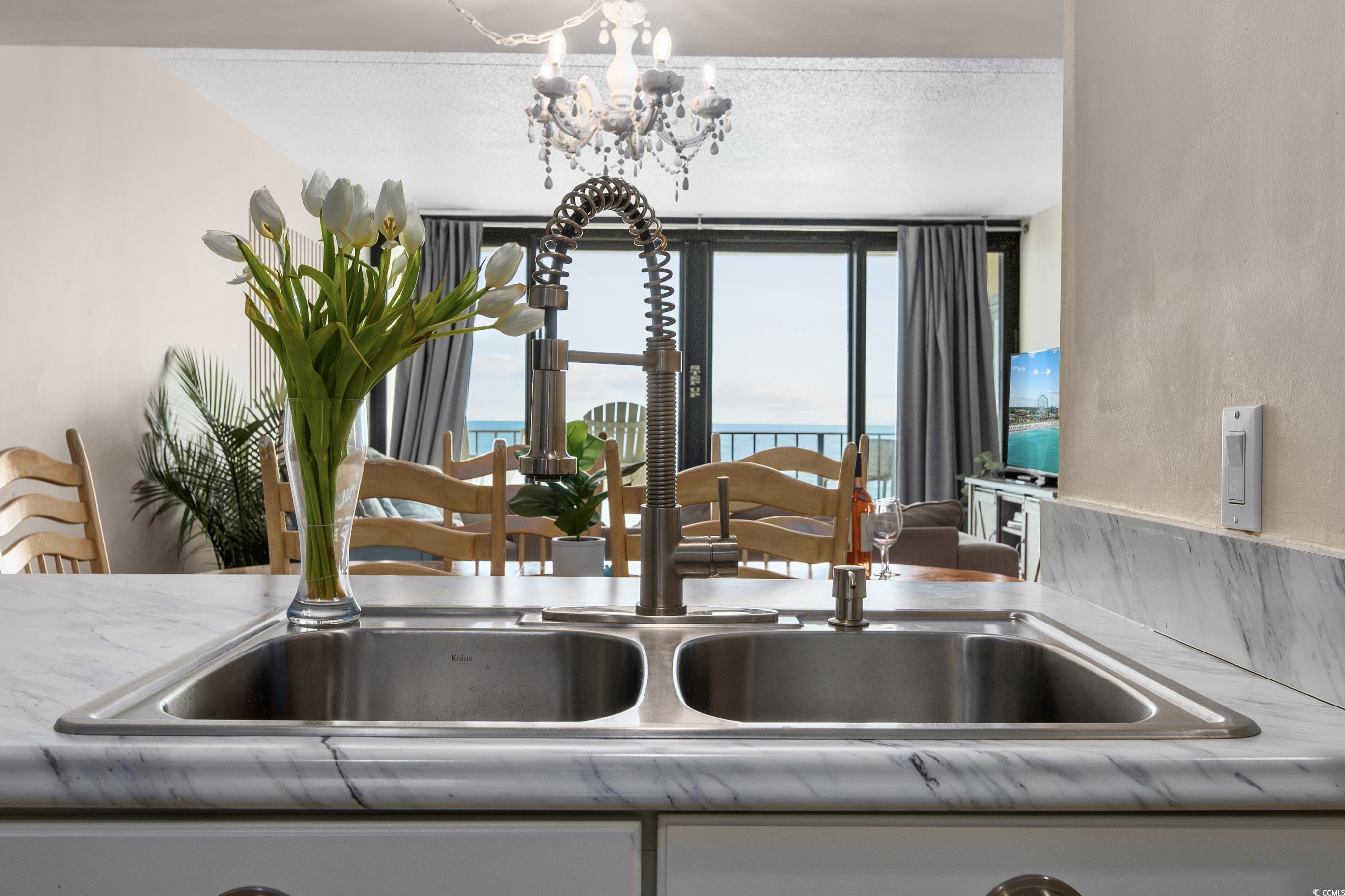 1108 North Waccamaw Drive, Unit 304 Murrells Inlet, SC 29576 - Photo 11 of 34 Kitchen view of light countertops and a chandelier