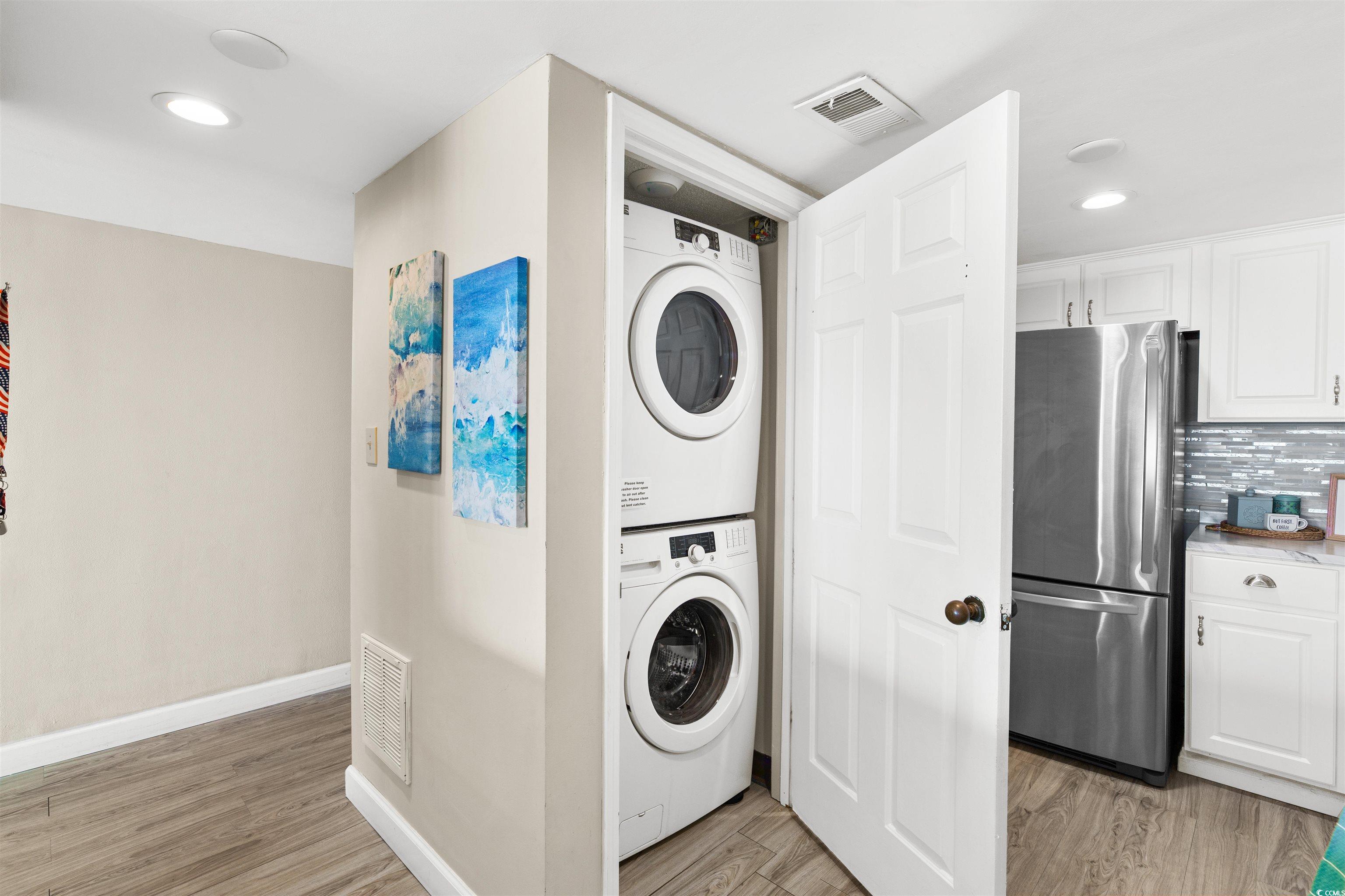 1108 North Waccamaw Drive, Unit 304 Murrells Inlet, SC 29576 - Photo 12 of 34 Washroom with light wood-style floors, recessed lighting, and estacked washer and dryer
