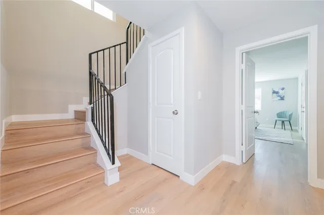 a view of a hallway with wooden floor and entryway