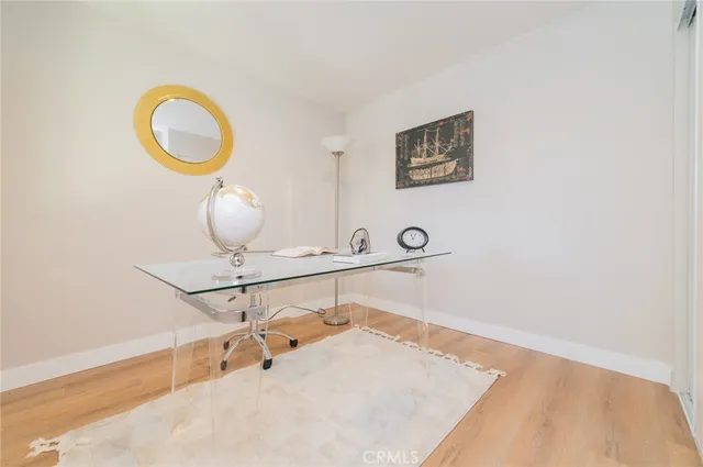 a view of a room with wooden floor and bathroom
