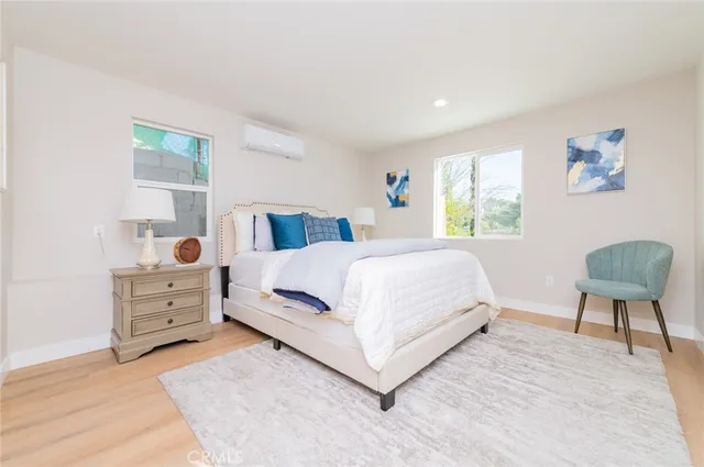 a bedroom with a bed and a chair