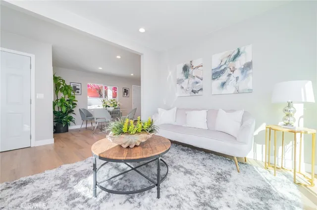 a living room with furniture and a potted plant