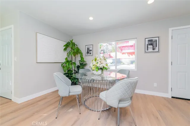 a dining room with furniture and wooden floor
