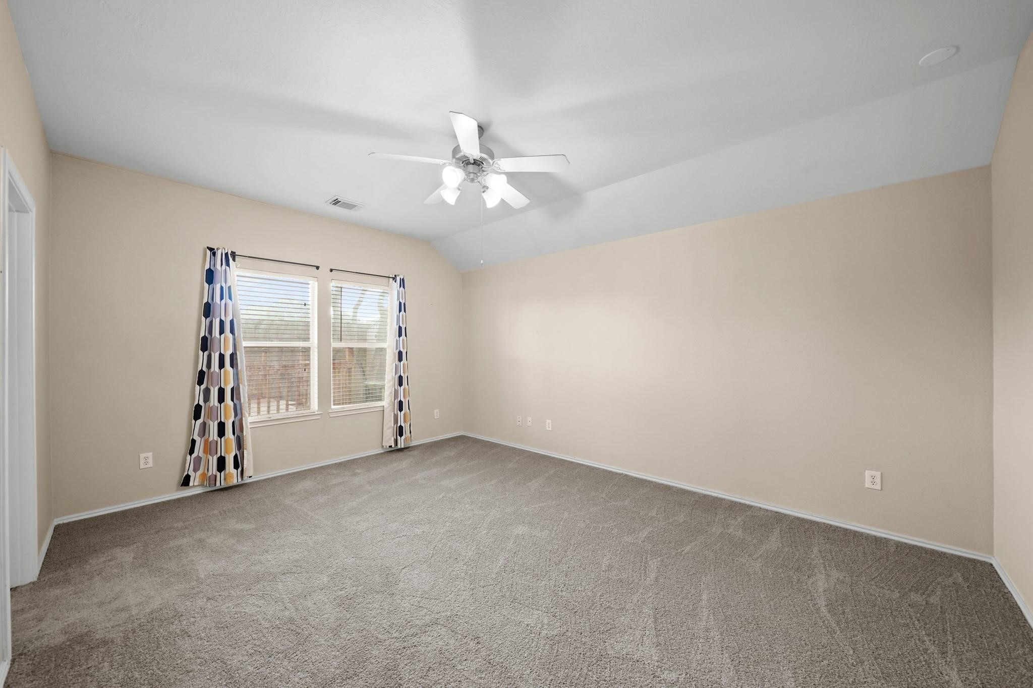2813 Waterside Trail Pearland, TX 77584 - Photo 14 of 25 an empty room with a ceiling fan and window