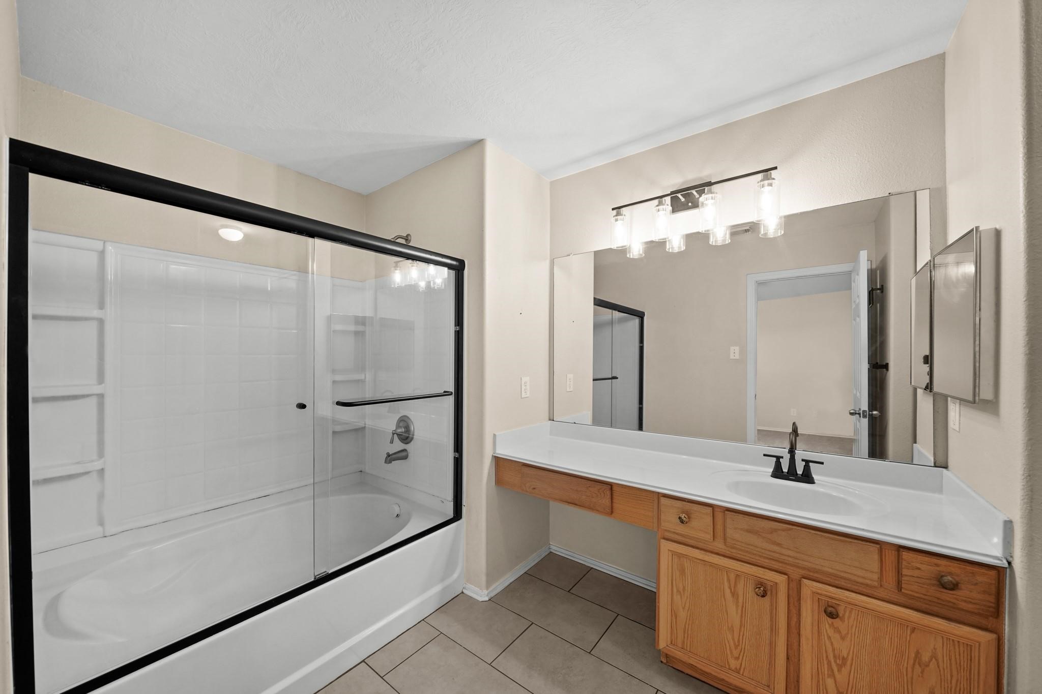 2813 Waterside Trail Pearland, TX 77584 - Photo 16 of 25 a bathroom with a double vanity sink mirror and shower