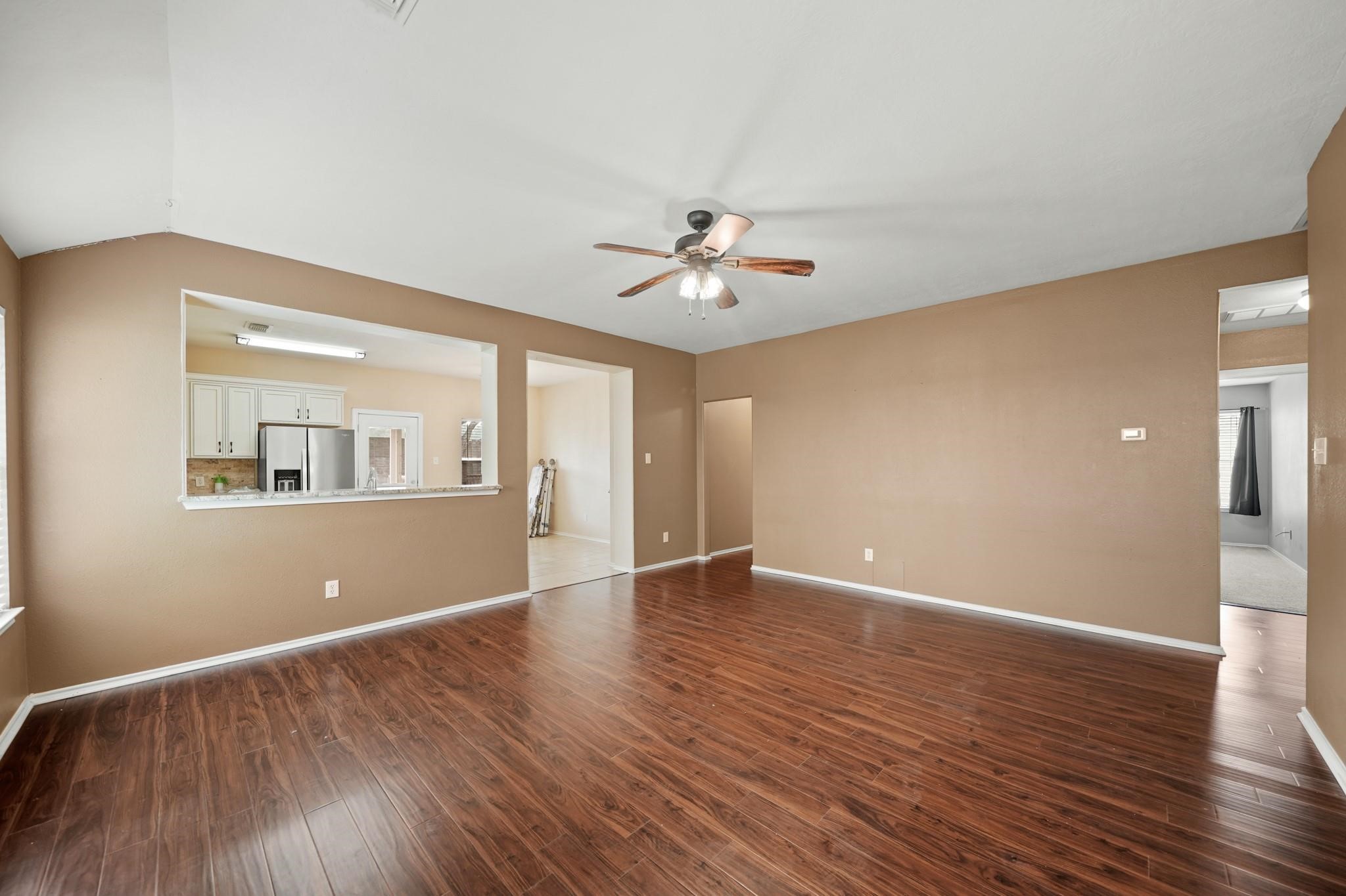 2813 Waterside Trail Pearland, TX 77584 - Photo 6 of 25 a view of an empty room with window and wooden floor