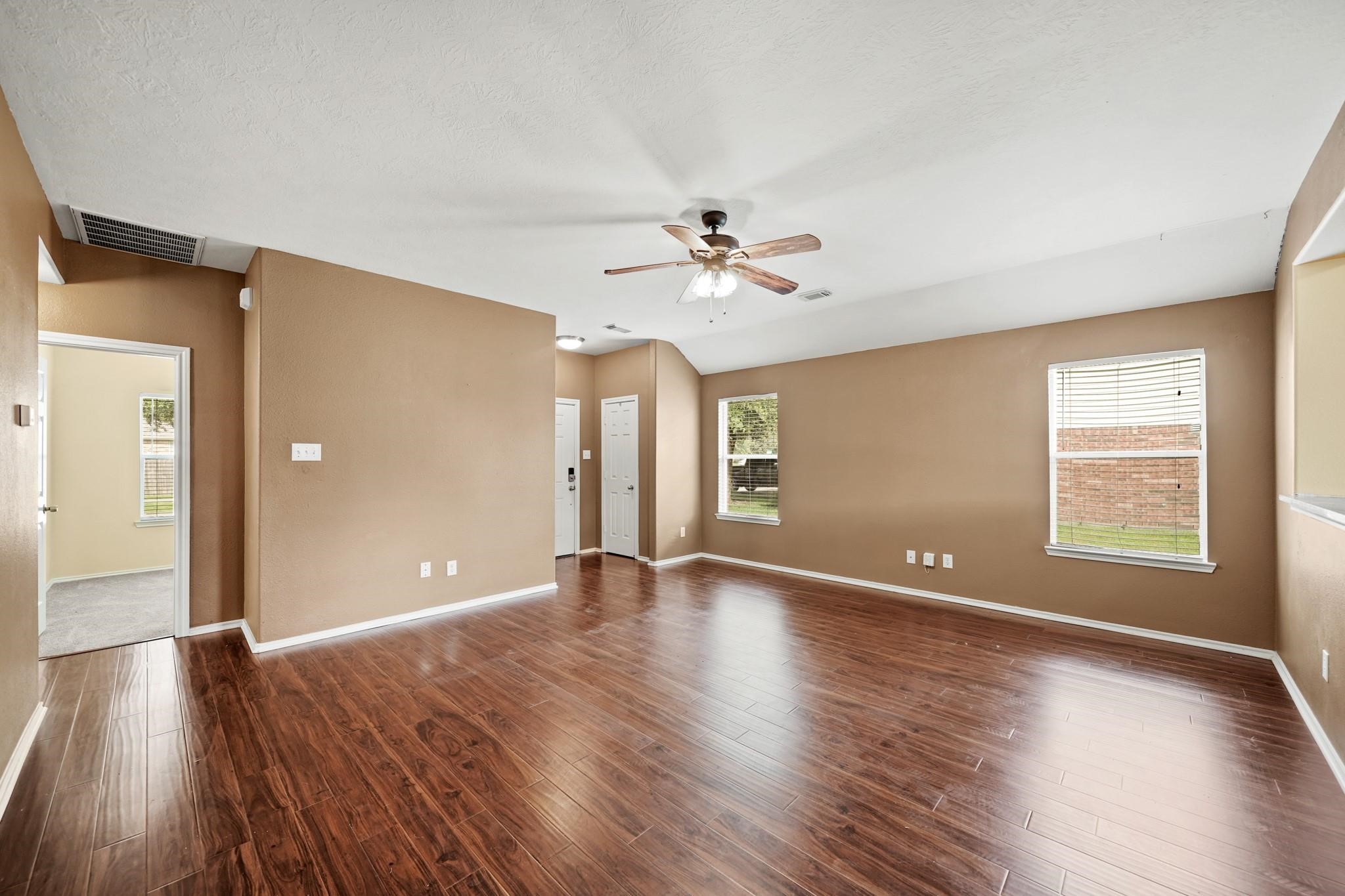 2813 Waterside Trail Pearland, TX 77584 - Photo 7 of 25 a view of an empty room with window and wooden floor