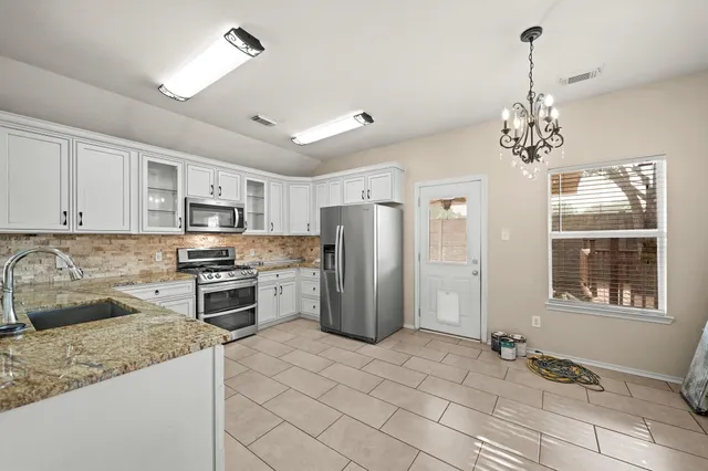 a kitchen with a stove sink and refrigerator