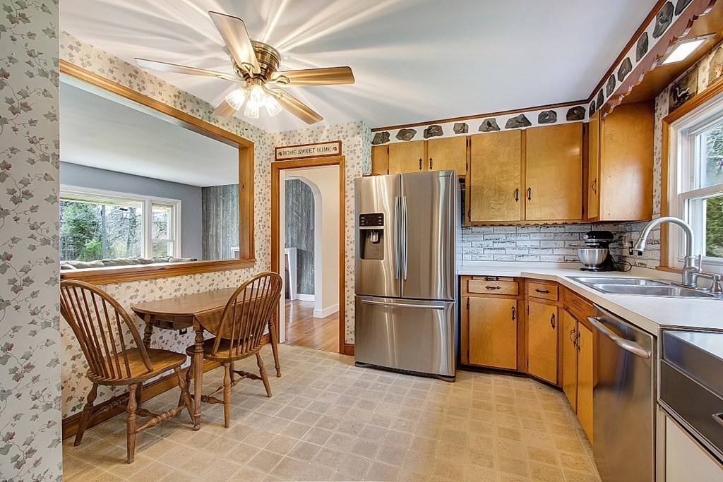 172 Minott Road Gardner, MA 01440 - Photo 8 of 36 a kitchen with stainless steel appliances granite countertop furniture a refrigerator a sink a stove and a dining table