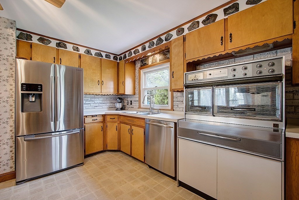 172 Minott Road Gardner, MA 01440 - Photo 9 of 36 a kitchen with granite countertop stainless steel appliances a refrigerator cabinets and a sink