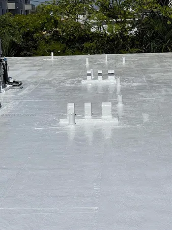 a kitchen with wooden floor and electronic appliances