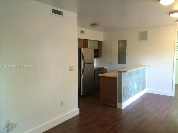 a kitchen with a refrigerator and a sink