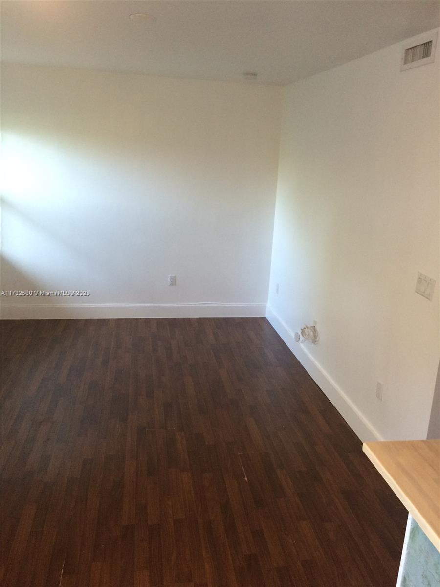7025 Rue Granville, Unit 3 Miami Beach, FL 33141 - Photo 10 of 21 a view of room with wooden floor