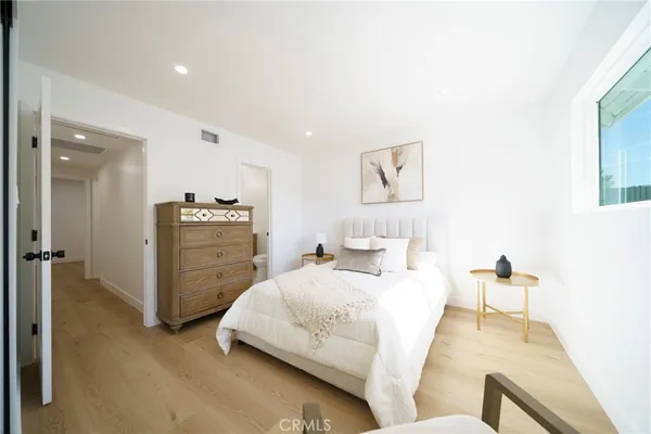 a bedroom with bed and cabinet