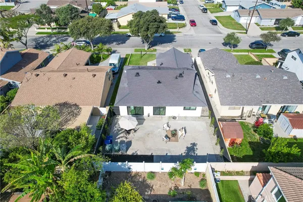 an aerial view of a house with a garden and trees