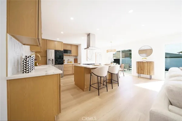 a living room with furniture and a kitchen view