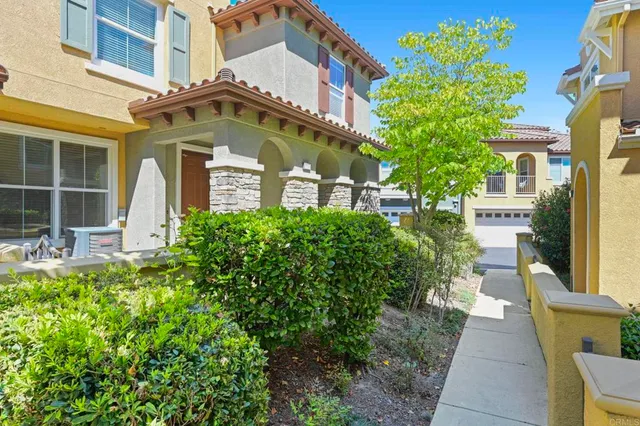 a front view of a multi story residential apartment building with a yard