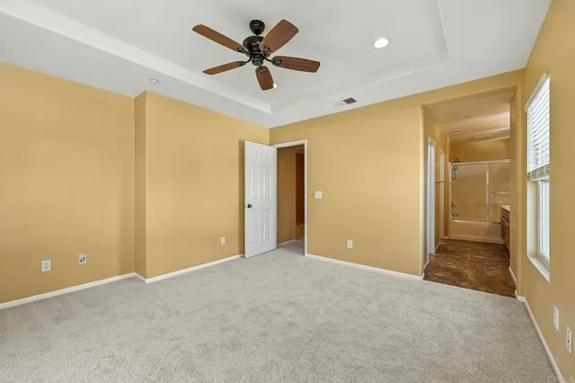 a view of a livingroom with a ceiling fan and window