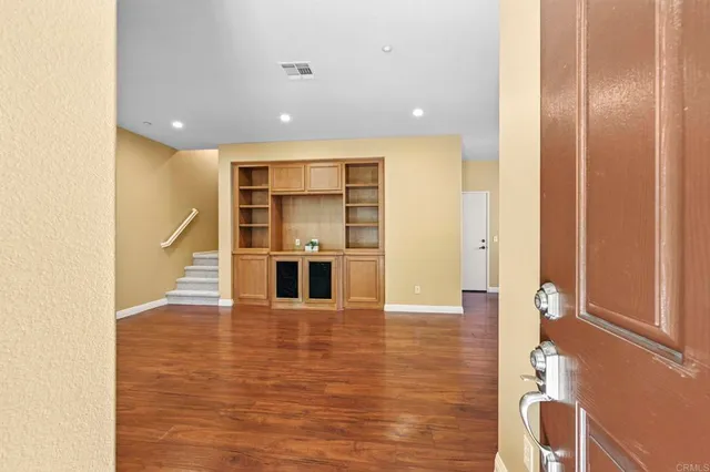 a view of a kitchen with wooden floor and staircase