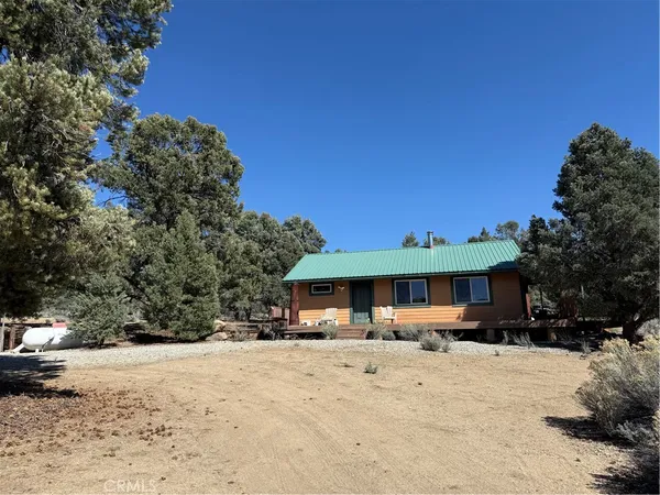 a kitchen with stainless steel appliances granite countertop a refrigerator a stove a sink dishwasher a dining table and chairs with wooden floor
