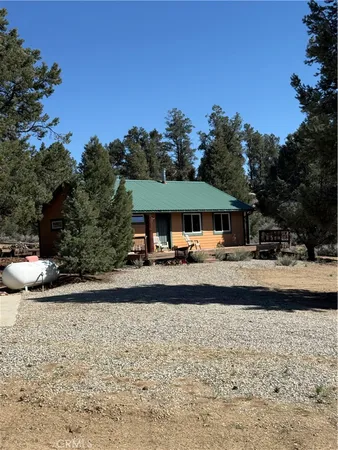 a view of a wooden bridge with trees in the background