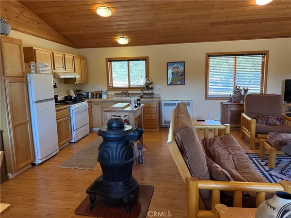 a living room with furniture a flat screen tv and a window