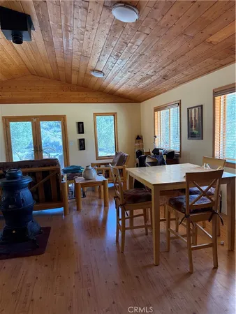 a wooden bench sitting in the middle of a yard