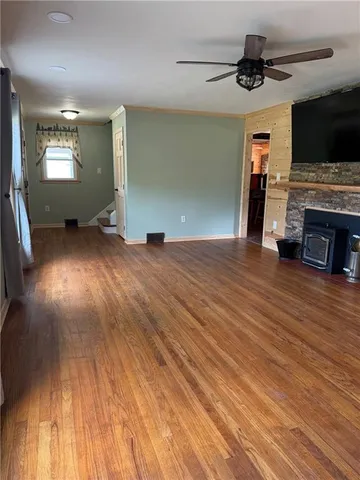 a bathroom with a sink a toilet a mirror and shower